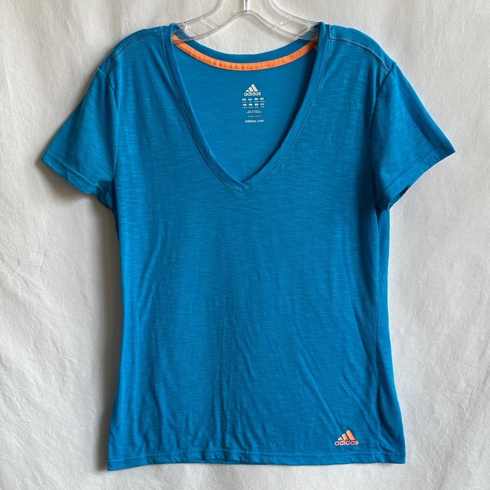 Adidas vibrant blue V-neck tee with orange logo, size M